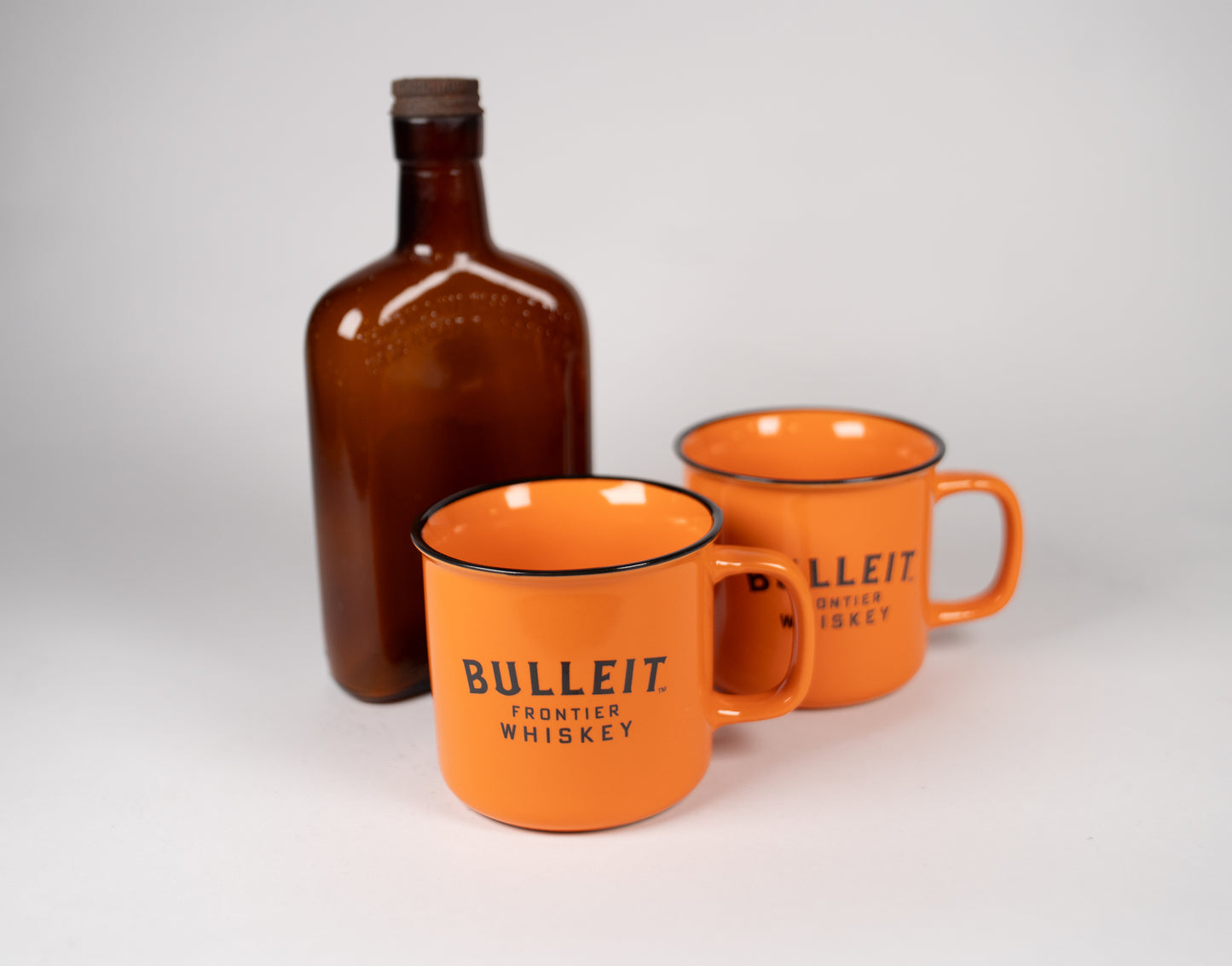 Vintage Brown Glass 4/5 Pint Bottle with Two Bullet Frontier Whiskey Mugs. Lot #79